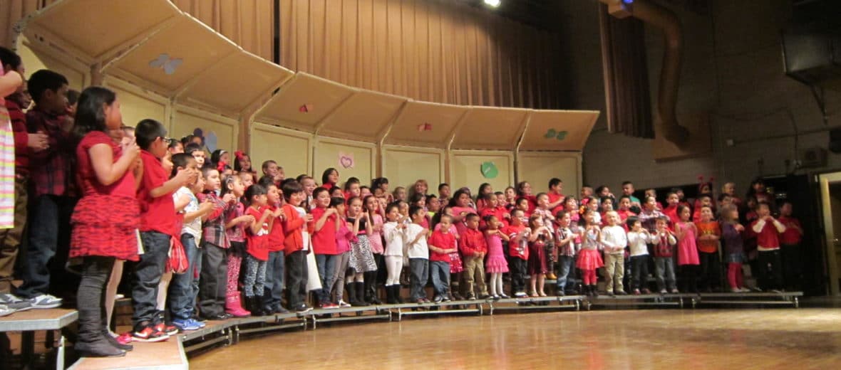 Children standing on a stage for a school performance