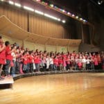 Children standing on a stage for a school performance