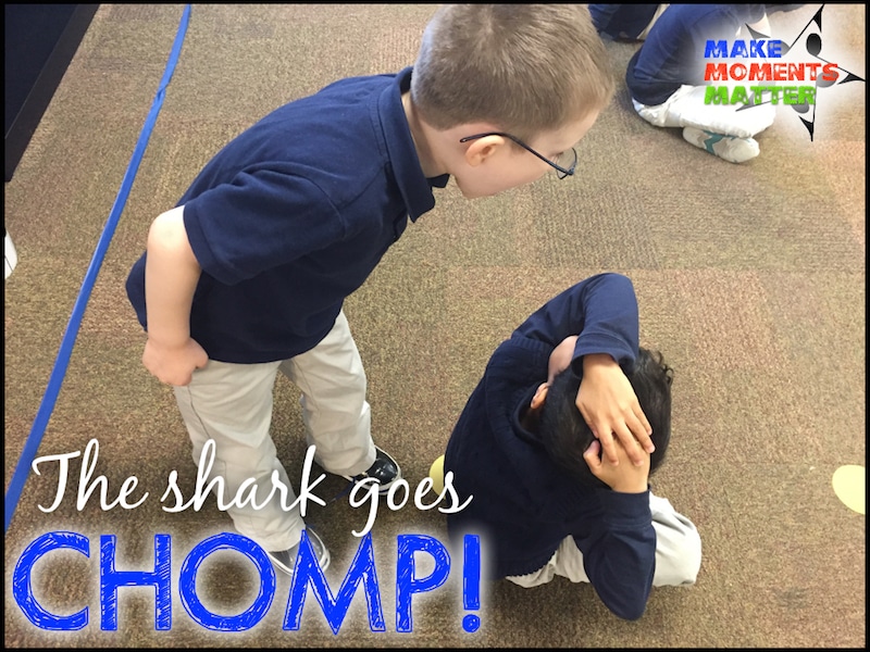Two Children "chomping" on one another like sharks.