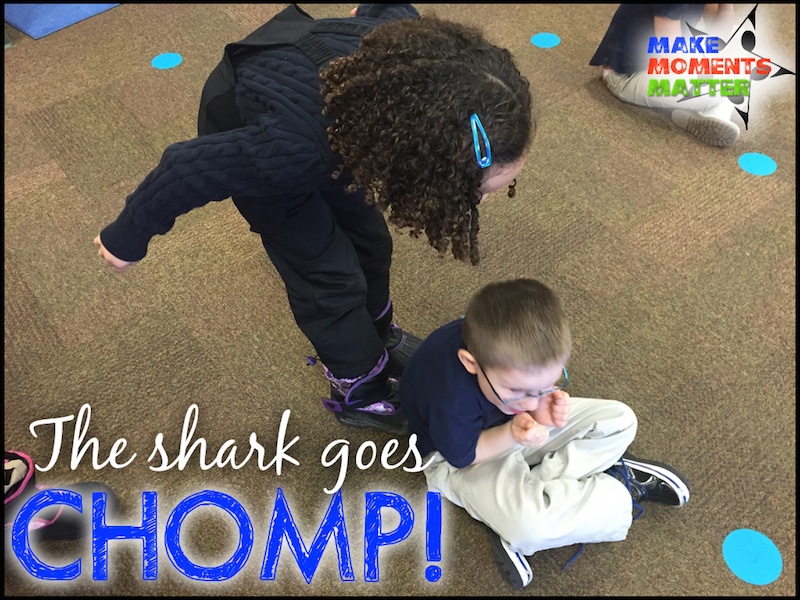 Two Children "chomping" on one another like sharks.