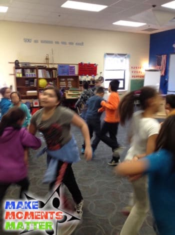 Students dancing with the prompt "swing your partner"