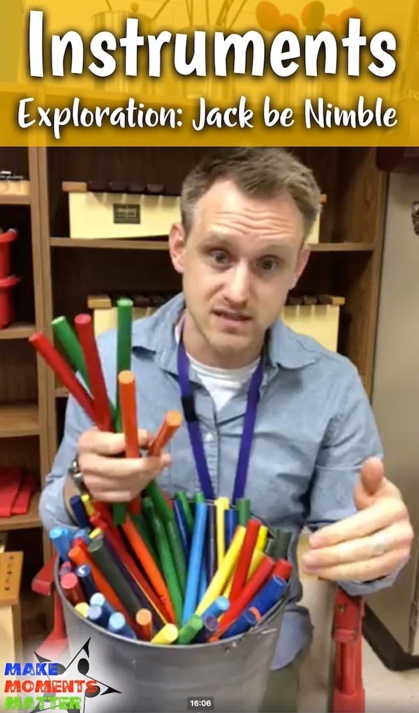 Music teacher holding rhythm sticks.